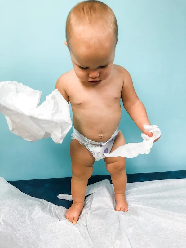 baby playing with the paper at the pediatrician office