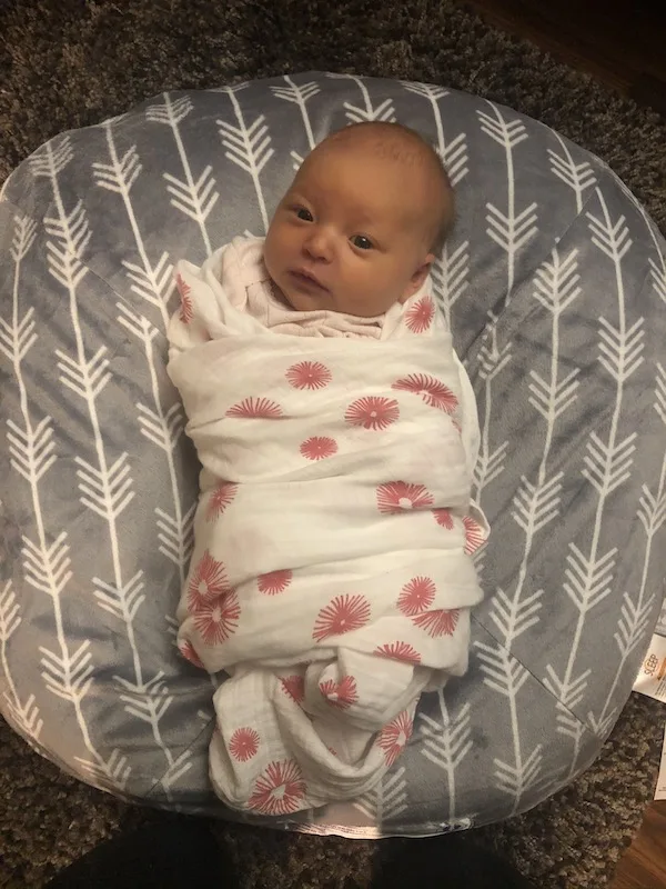 newborn in oliver and rain swaddle